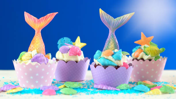 istock Mermaid theme cupcakes with colorful glitter tails, shells and sea creatures 1021365604