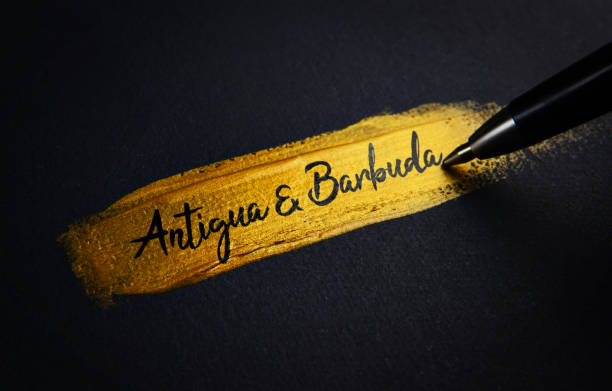 istock Antigua and Barbuda Handwriting Text on Golden Paint Brush Stroke 1021374562