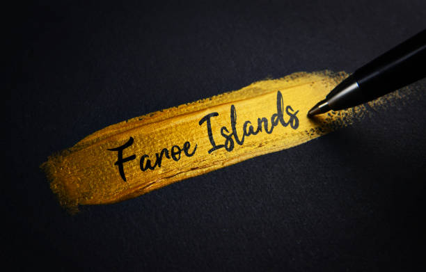 istock Faroe Islands Handwriting Text on Golden Paint Brush Stroke 1021382840