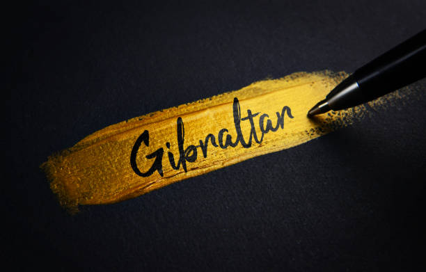 istock Gibraltar Handwriting Text on Golden Paint Brush Stroke 1021382990