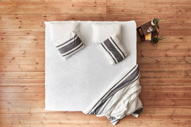 istock Directly Above Empty Bed on wooden floor 1021387500