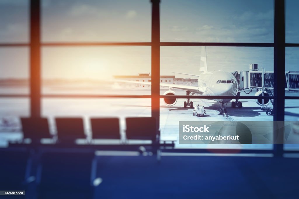 airplane waiting for departure in airport terminal airplane waiting for departure in airport terminal, blurred horizontal background with place for text Airport Stock Photo