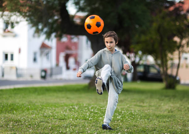 istock Boy play with football ball 1021389982