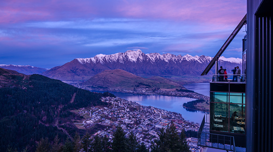 Remarkables mountain range and Queenstown during sunset photo taken from Bobs Peak. Skyline Queenstown and Restaurant visible in photo.