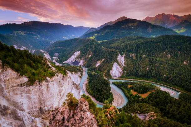 Sunrise over the Ruinaulta Crimson clouds in the dawn sky at the Ruinaulta, a canyon created by the Anterior Rhine in the debris of the Flims rockslide, eastern Switzerland. Also known as the Rhine Gorge, or the Swiss Grand Canyon. graubunden canton stock pictures, royalty-free photos & images