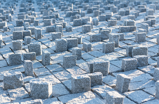 Granite bricks background under sunlight morning. Granite brick structure on the ground to prevent pedestrian crossing in the area of Cuatro Torres Business Area of Madrid, Spain