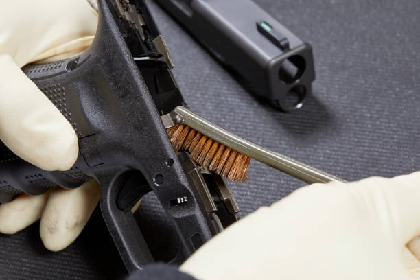 istock Using a Steel Brush to Clean a Hand Gun 1021455772