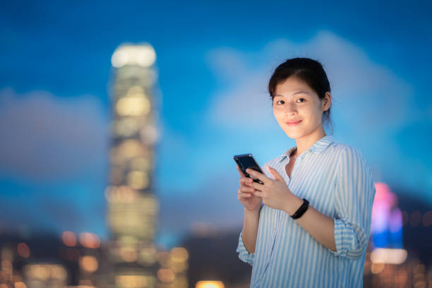 istock Young woman using smartphone at night 1021468510