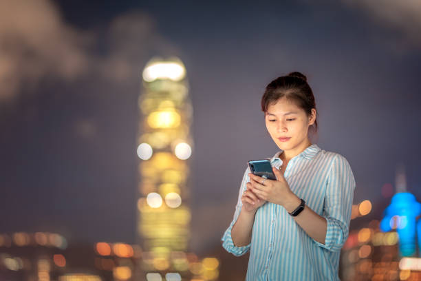 istock Young woman using smartphone at night 1021468602