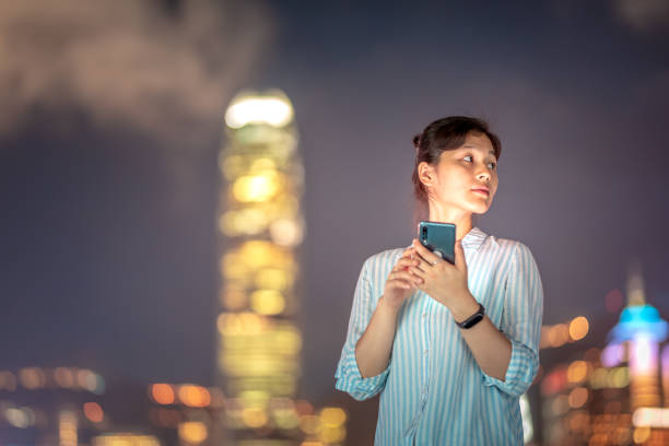 istock Young woman using smartphone at night 1021468634