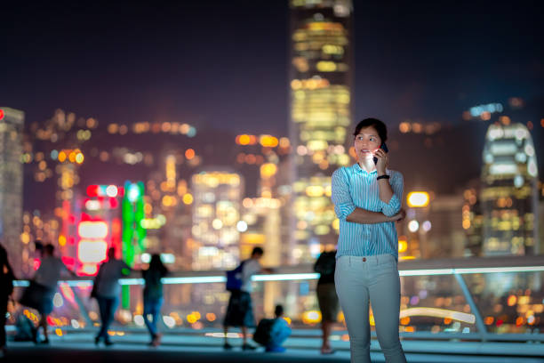 istock Young woman using smartphone at night 1021468664