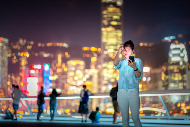 istock Young woman using smartphone at night 1021468686