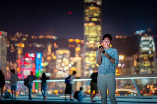 istock Young woman using smartphone at night 1021468720