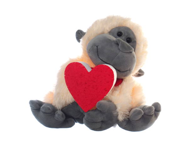 istock monkey stuffed soft toy holding red heart symbol on white background 1021474012