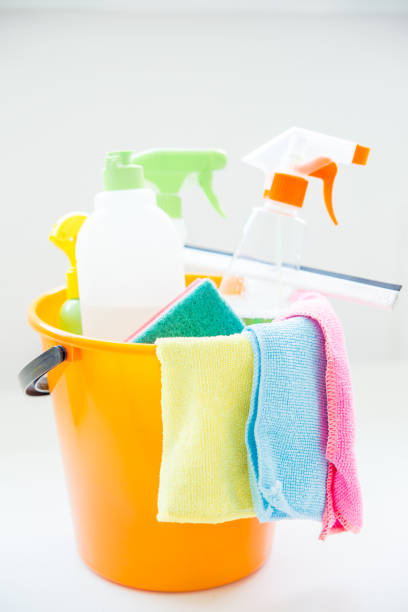 istock Bucket with cleaning supplies and tools on table 1021497546