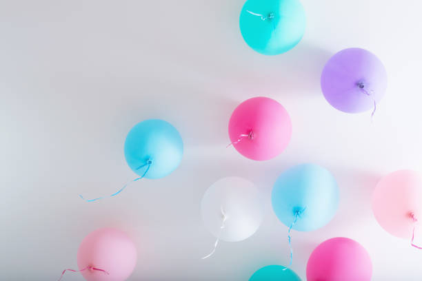 istock balloons on white wooden background 1021497882