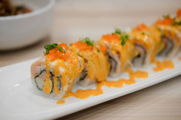 istock Salmon sushi or salmon roll on white plate 1021513308