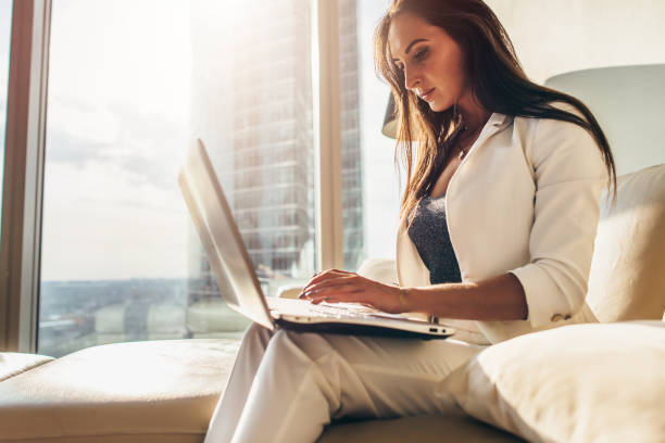 istock Side view of young woman working on laptop 1021521284
