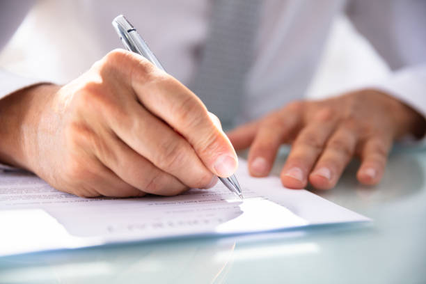 istock Businessman Filling Contract Form 1021542886