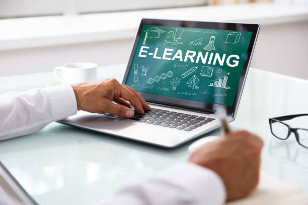 istock Businessman With Laptop Showing E-learning Concept On Screen 1021542900