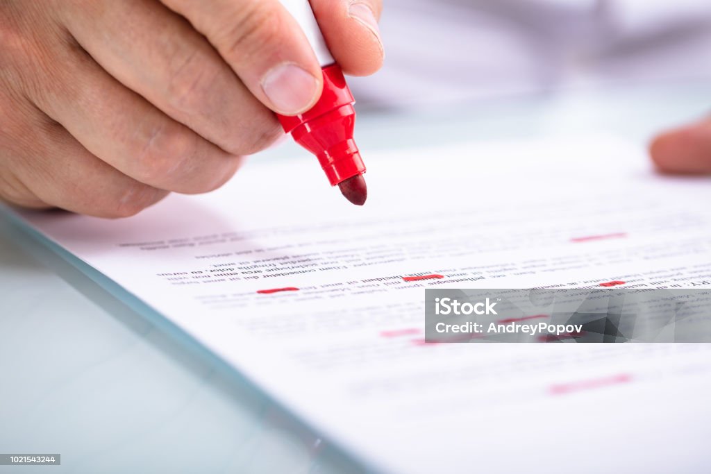 Businessperson Holding Marker On Document Close-up Of A Businessperson's Hand Holding Marker On Document Document Stock Photo