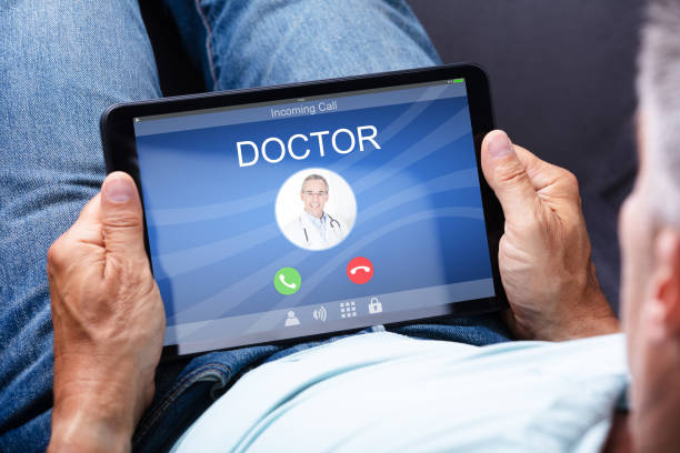 istock Man Holding Digital Tablet With Doctor's Call On Display 1021543470