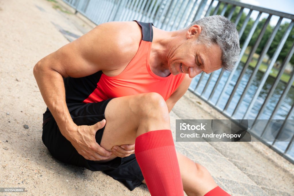 Man With Sprain Thigh Muscle Close-up Of A Mature Man With Sprain Thigh Muscle Hamstring Stock Photo