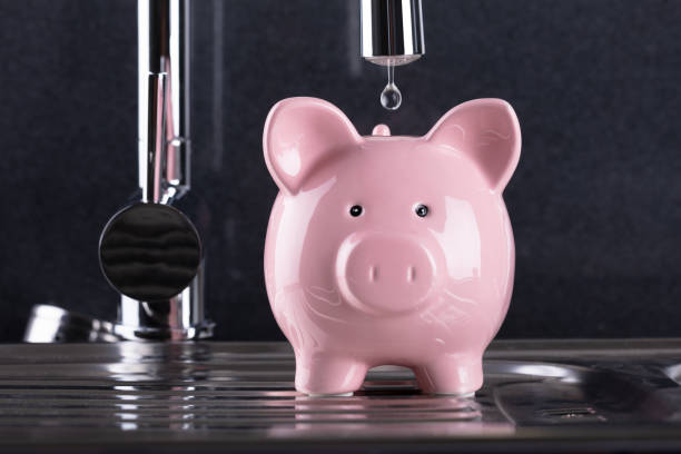 istock Water Droplet Falling In Piggybank 1021544134