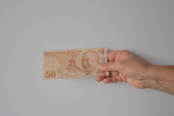 istock Turkish lira held on a gray background 1021552378
