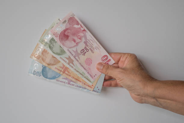Turkish lira held on a gray background