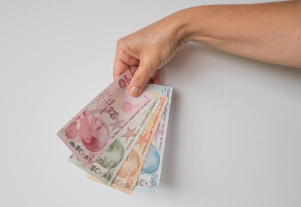 istock Turkish lira held on a gray background 1021552516