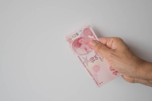 istock Turkish lira held on a gray background 1021552550