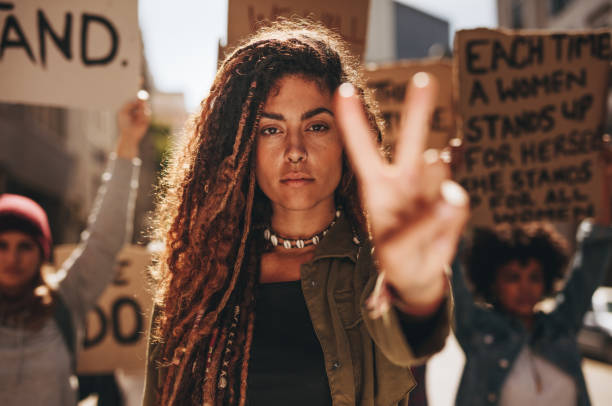 istock Woman showing a peace sign during protest 1021562758