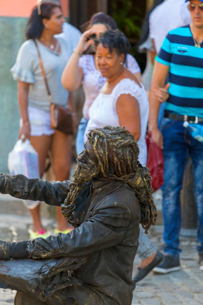Havana Cuba Feb 14 2018: Unidentified buskers -living statue - putting up a show for the tourist in Old Havana.  These type of entertainment is part of the local culture for tourist as well as for locals.