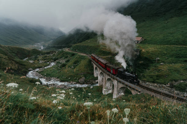 Steam locomotive in Furka Pass  valley Scenic view of steam locomotive in Furka Pass, Switzerland furka pass photos stock pictures, royalty-free photos & images