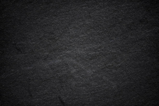istock Dark grey black slate background or natural stone texture. 1021580388