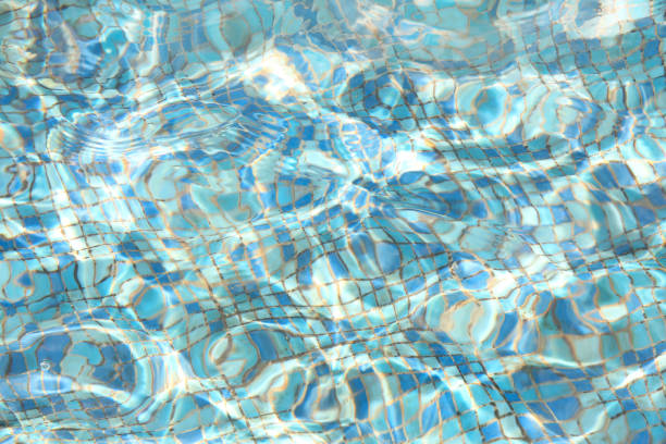 Beautiful transparent blue water texture and a bottom of the fountain.