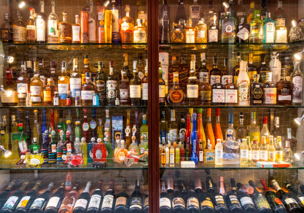 Venice, Italy - September 2, 2017: Wide angle view of a large selection of different bottles of rum, wine and whisky on display at a liquor stall in Venice, Italy.