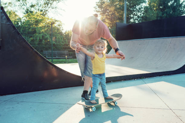 istock Modern dad with three year old son in skate park 1021586960
