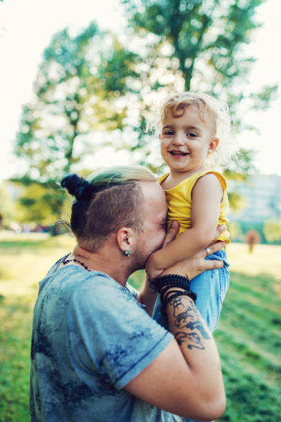 istock Playful father and three year old son in park 1021589816