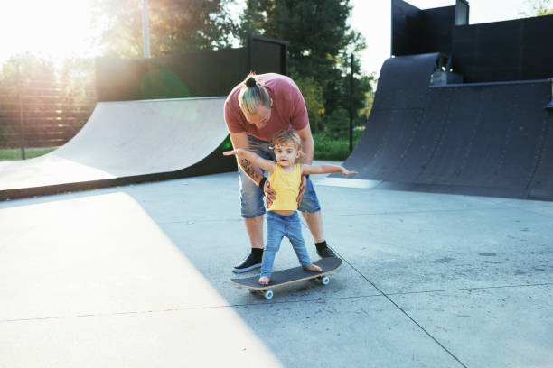istock Modern dad with three year old son in skate park 1021593212