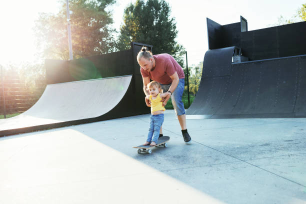 istock Modern dad with three year old son in skate park 1021593372