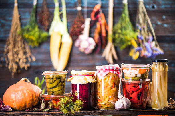 Pickled Marinated Fermented vegetables on shelves Pickled Marinated Fermented vegetables on shelves in cellar preserved stock pictures, royalty-free photos & images