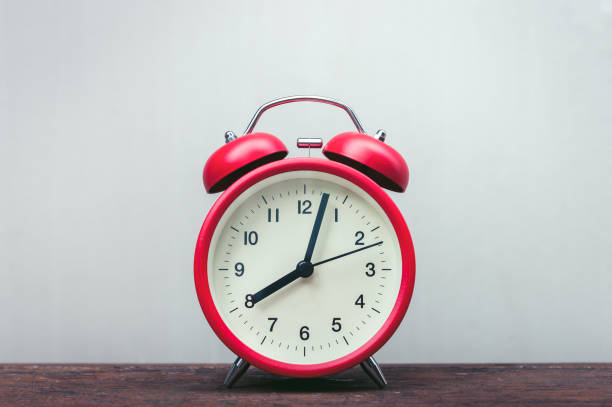 istock Red alarm clock on wooden table. 1021599368