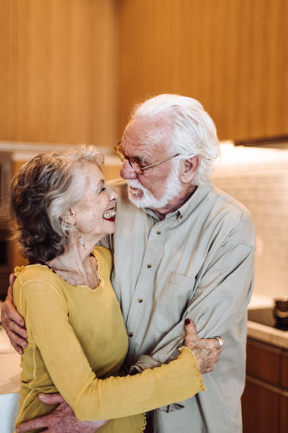 istock senior couple kissing on the kitchen 1021606098