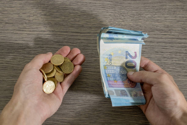 istock Currency, hands are holding euro coins and banknote composition 1021608304