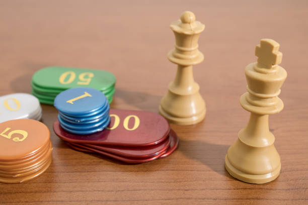 istock Table gamings, chess and casino chips on a wood table composition 1021608348