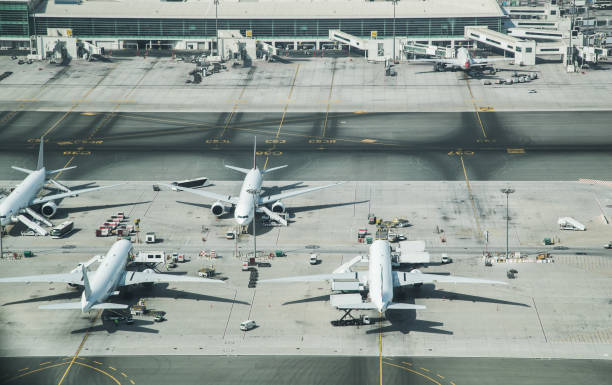 Aerial view of parked airplanes in the airport terminal. Aerial view of parked airplanes in the airport terminal. Modern and fastest mode of transportation. airport aerial view stock pictures, royalty-free photos & images