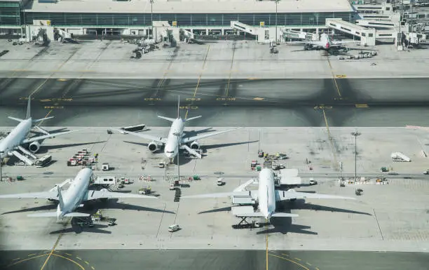 Aerial view of parked airplanes in the airport terminal. Modern and fastest mode of transportation.