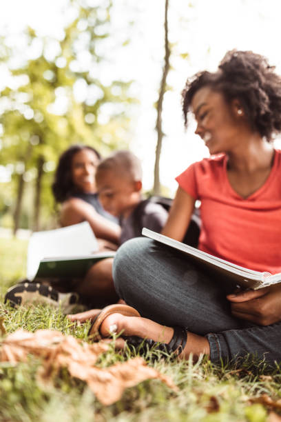 istock family doing the homework in the park 1021620352